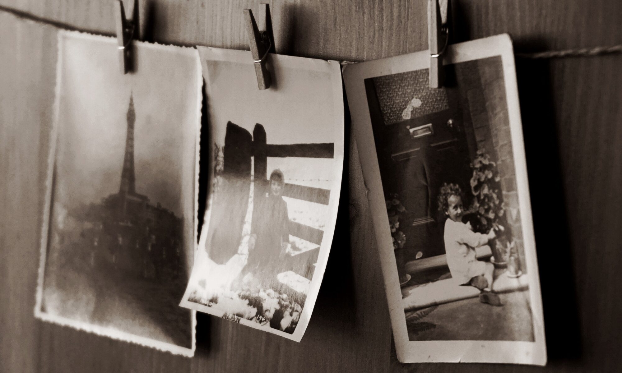 Vintage black-and-white photographs pinned to a clothesline