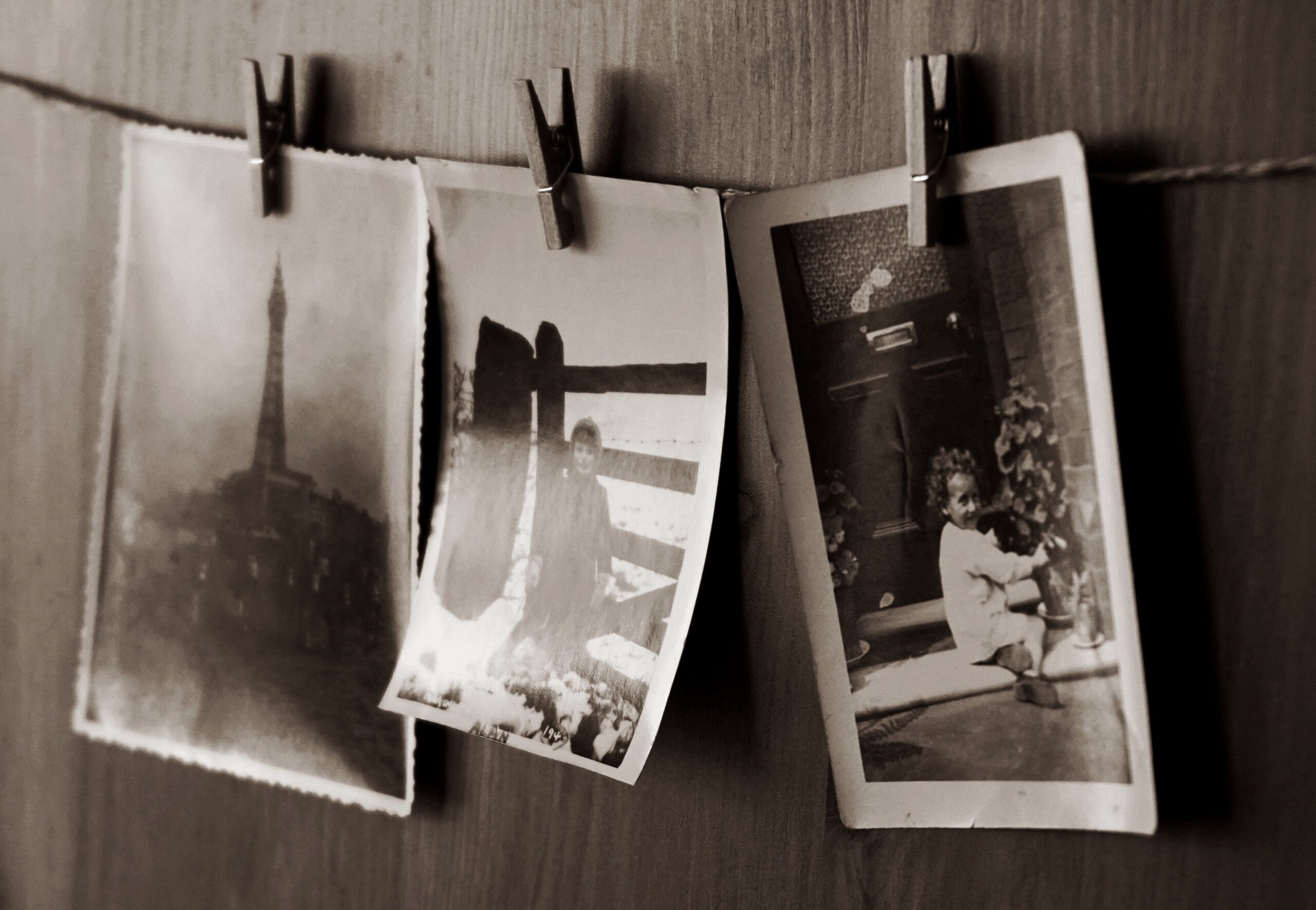Vintage black-and-white photographs pinned to a clothesline